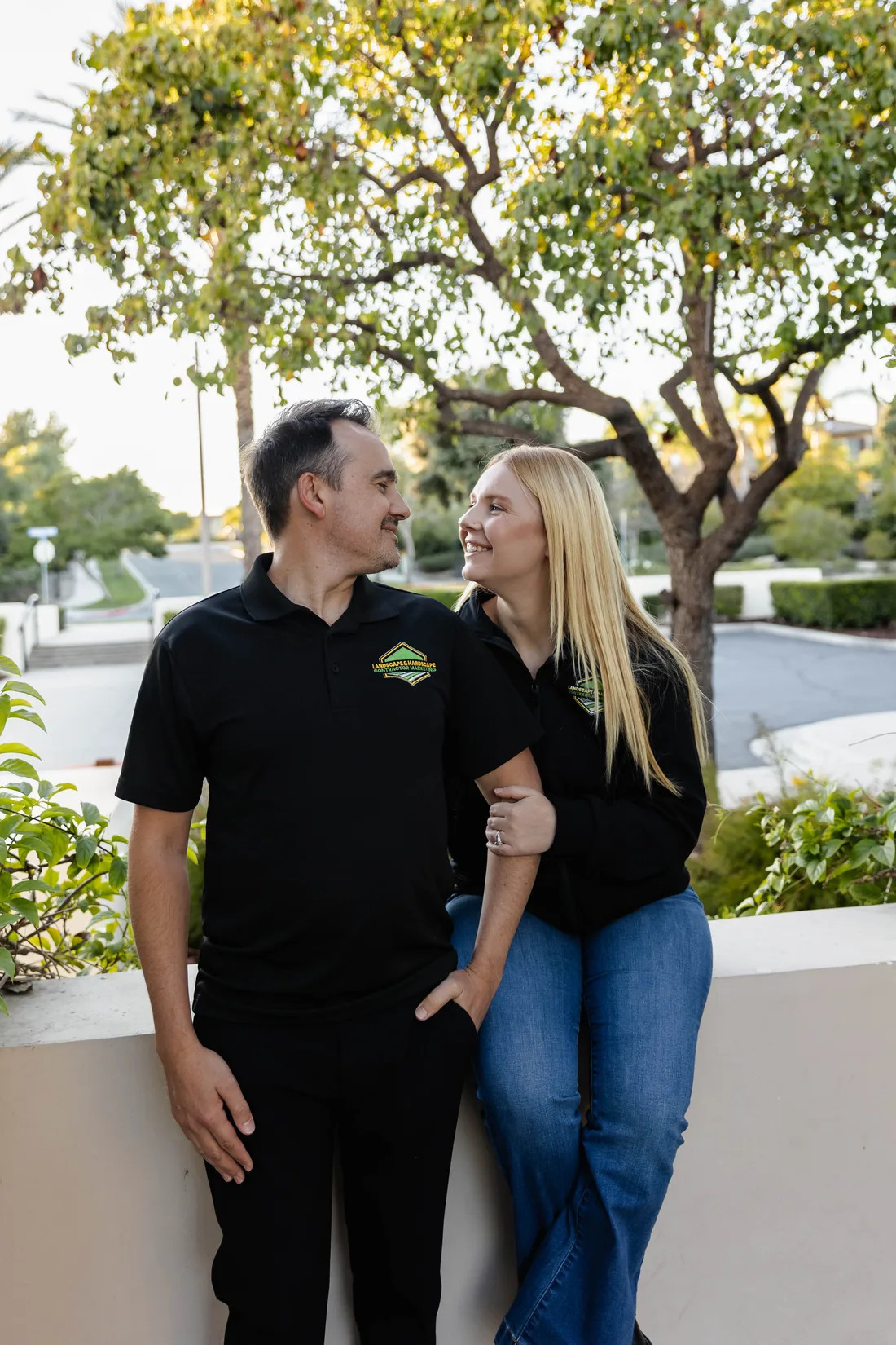 Josh and Chelle Blakeley of Landscape & Hardscape Contractor Marketing sharing a laugh outdoors